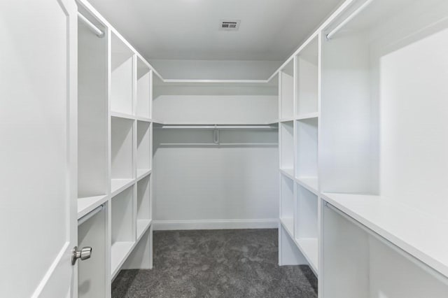 spacious closet featuring visible vents and dark carpet