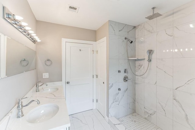 bathroom featuring a sink, visible vents, a marble finish shower, and marble finish floor