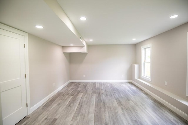 unfurnished room featuring recessed lighting, light wood-style flooring, and baseboards