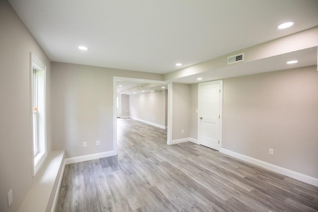 unfurnished room with recessed lighting, visible vents, baseboards, and wood finished floors