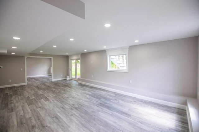 empty room featuring recessed lighting, baseboards, and wood finished floors