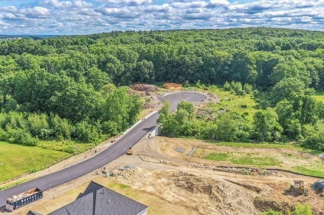 birds eye view of property with a view of trees