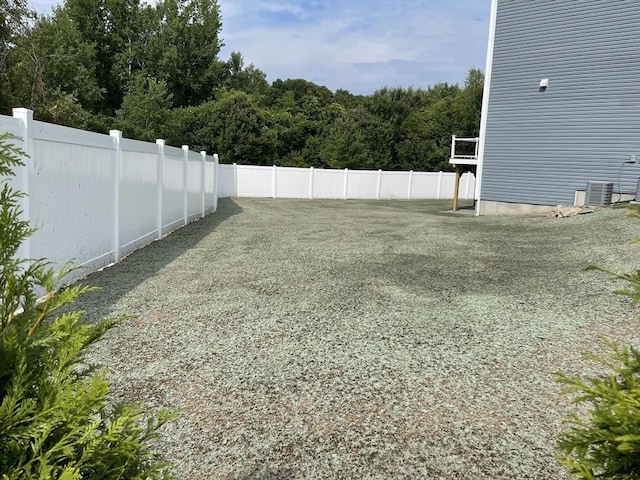 view of yard featuring cooling unit and fence