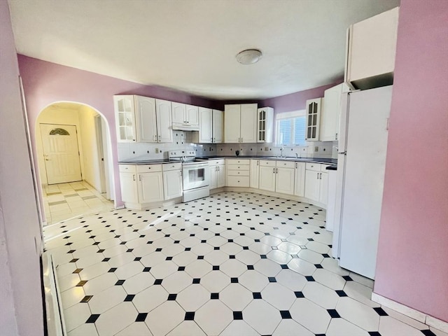 kitchen with white cabinetry, white appliances, sink, and backsplash