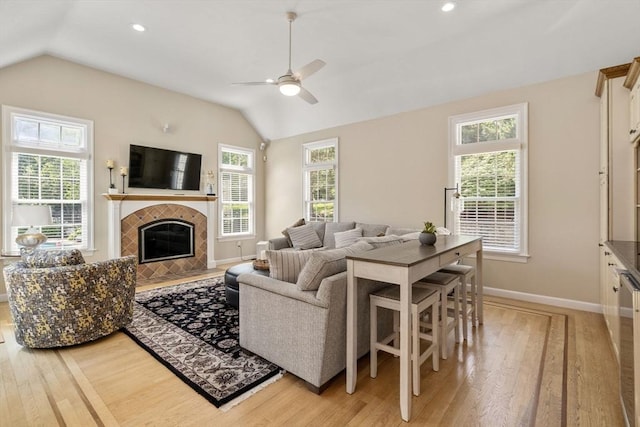 63 High St, Shrewsbury, MA 01545 - living room featuring vaulted ceiling, light wood finished floors, baseboards, and ceiling fan