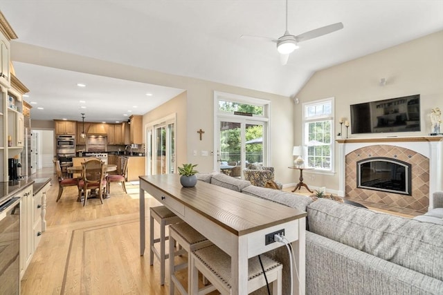 63 High St, Shrewsbury, MA 01545 - living area with a ceiling fan, a tile fireplace, light wood-style flooring, lofted ceiling, and recessed lighting