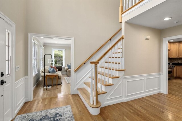 63 High St, Shrewsbury, MA 01545 - foyer with a decorative wall, light wood finished floors, and stairs