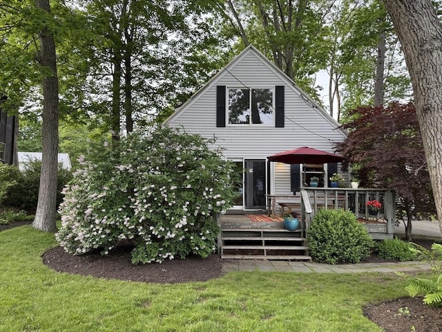 26 Horseshoe Cir, Ware, MA 01082 - back of house featuring a wooden deck and a lawn