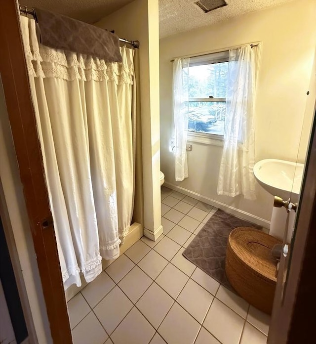26 Horseshoe Cir, Ware, MA 01082 - full bathroom with tile patterned floors, toilet, a textured ceiling, a shower with curtain, and baseboards