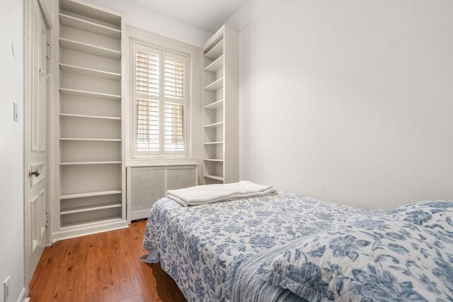 bedroom with wood finished floors