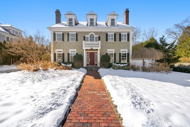 colonial-style house with a chimney