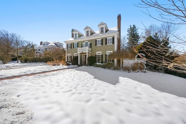 colonial inspired home featuring a chimney