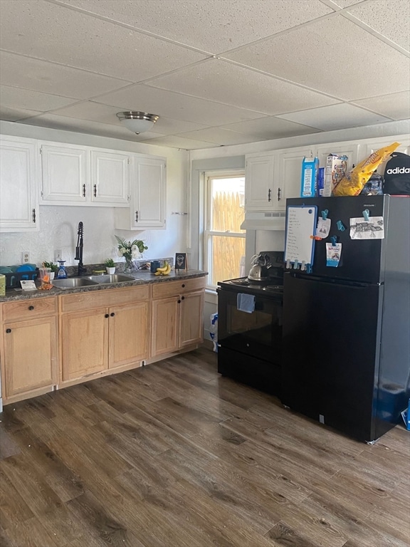 kitchen featuring black appliances, sink, a paneled ceiling, white cabinets, and dark wood-type flooring