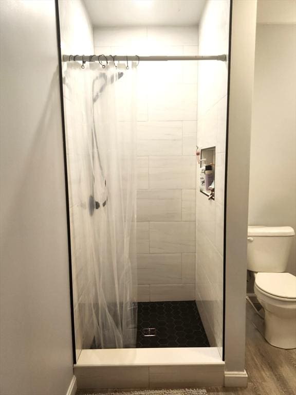 202 Broadway Unit 2-1, Lawrence, MA 01840 - bathroom with a stall shower, toilet, and wood finished floors