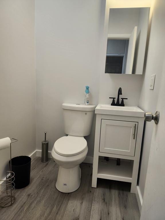 202 Broadway Unit 2-1, Lawrence, MA 01840 - bathroom featuring wood finished floors, vanity, baseboards, and toilet