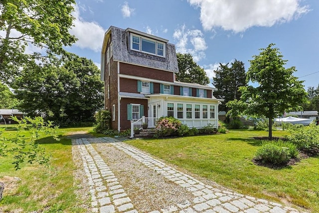 34 Kenwood Rd, Bourne, MA 02559 - back of house featuring driveway and a lawn