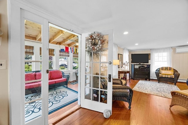 34 Kenwood Rd, Bourne, MA 02559 - doorway with wood finished floors, an AC wall unit, french doors, and beamed ceiling
