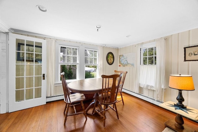 34 Kenwood Rd, Bourne, MA 02559 - dining area featuring wood finished floors, a baseboard radiator, and crown molding