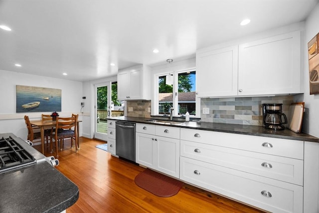 34 Kenwood Rd, Bourne, MA 02559 - kitchen featuring dishwasher, dark countertops, tasteful backsplash, white cabinetry, and wood finished floors