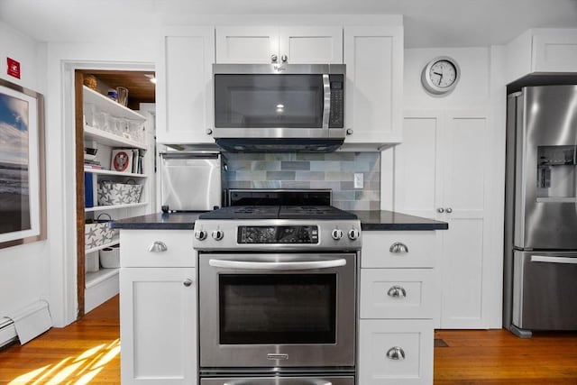 34 Kenwood Rd, Bourne, MA 02559 - kitchen with stainless steel appliances, wood finished floors, and white cabinets