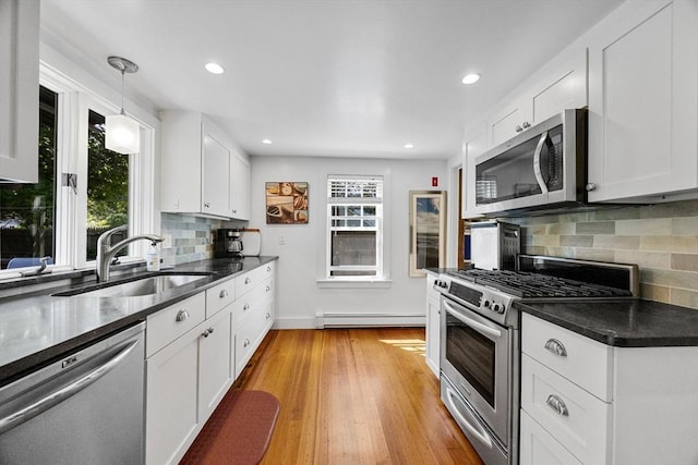 34 Kenwood Rd, Bourne, MA 02559 - kitchen with stainless steel appliances, a baseboard radiator, white cabinetry, backsplash, and recessed lighting