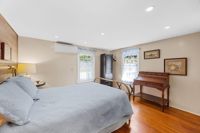 34 Kenwood Rd, Bourne, MA 02559 - bedroom featuring a wall mounted AC, wood finished floors, and recessed lighting