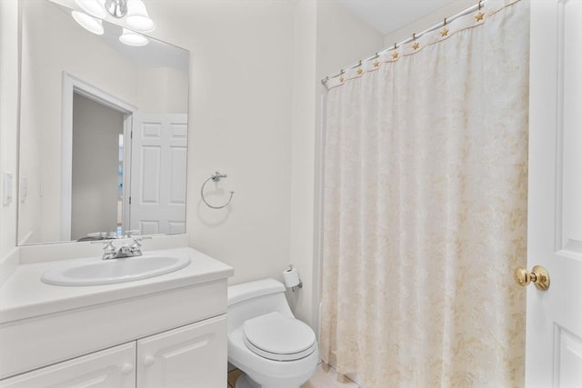 bathroom featuring toilet, vanity, and a shower with shower curtain