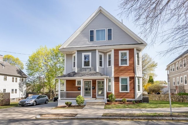 61 Paul Revere Rd Unit 2, Arlington, MA 02476 - american foursquare style home with a porch, aphalt driveway, and central AC unit