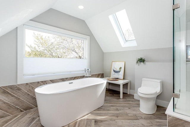 61 Paul Revere Rd Unit 2, Arlington, MA 02476 - bathroom featuring a shower with door, toilet, a freestanding tub, wood finished floors, and vaulted ceiling with skylight