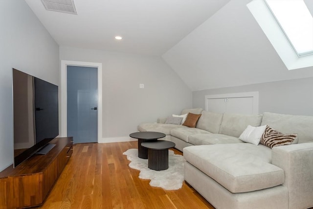 61 Paul Revere Rd Unit 2, Arlington, MA 02476 - living room featuring vaulted ceiling with skylight, visible vents, recessed lighting, light wood-style flooring, and baseboards