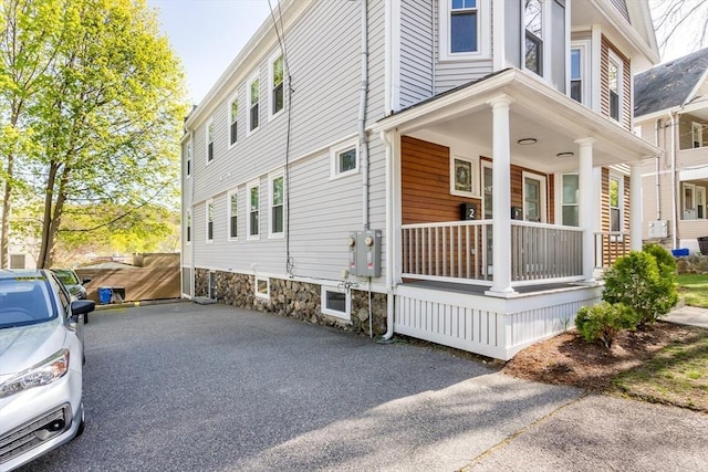 61 Paul Revere Rd Unit 2, Arlington, MA 02476 - view of side of property featuring a porch and aphalt driveway