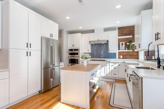 61 Paul Revere Rd Unit 2, Arlington, MA 02476 - kitchen with a sink, open shelves, backsplash, stainless steel appliances, and white cabinets