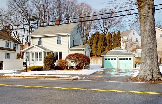 view of property with an outbuilding and a garage