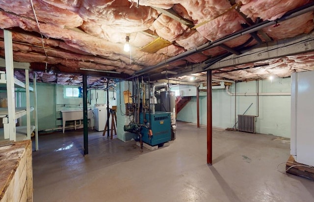 basement with separate washer and dryer, sink, and gas water heater