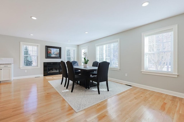 dining space with light hardwood / wood-style flooring