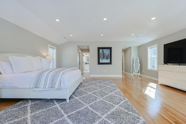 bedroom with hardwood / wood-style flooring and vaulted ceiling