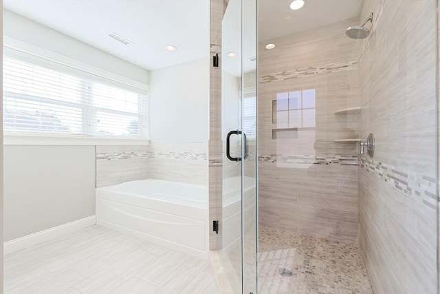 bathroom with separate shower and tub