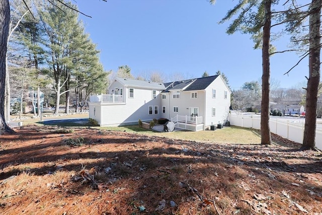 back of house featuring a balcony