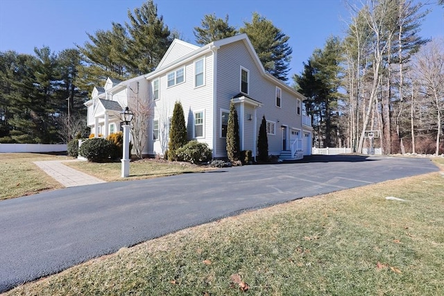 view of home's exterior featuring a garage and a yard