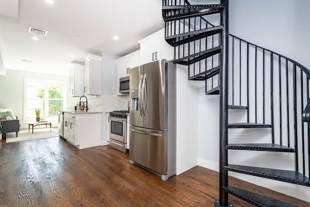 221 Paris St Unit 1, Boston, MA 02128 - kitchen featuring stainless steel appliances, dark wood-style flooring, white cabinets, light countertops, and recessed lighting