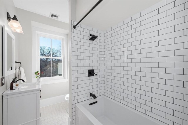 full bathroom with tile patterned floors, visible vents, toilet, shower / bathing tub combination, and vanity