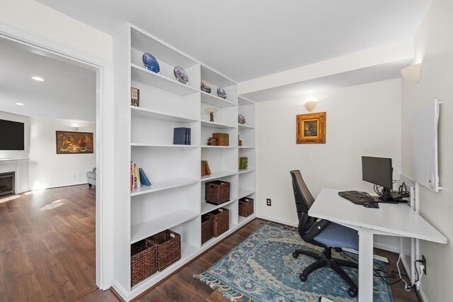 home office featuring a fireplace, recessed lighting, and wood finished floors