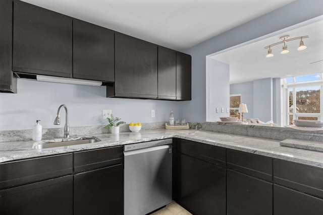 kitchen with sink, dishwasher, and light stone countertops