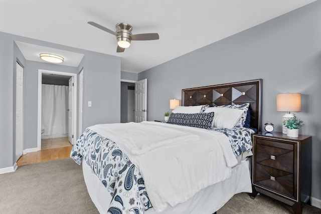 carpeted bedroom featuring ceiling fan and connected bathroom