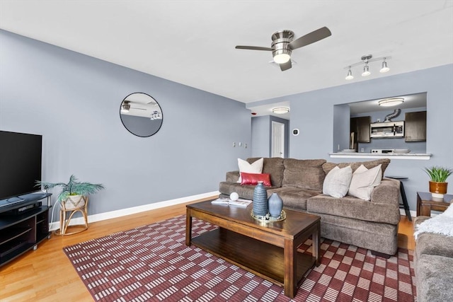 living room featuring hardwood / wood-style flooring and ceiling fan