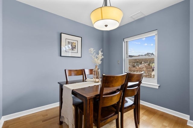 dining room featuring hardwood / wood-style floors and a healthy amount of sunlight