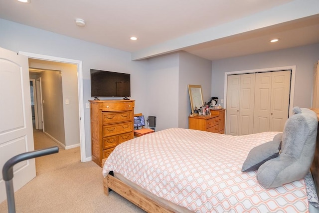 bedroom featuring recessed lighting, a closet, light carpet, and baseboards