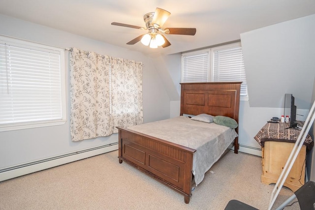 bedroom featuring a baseboard heating unit, light colored carpet, and ceiling fan