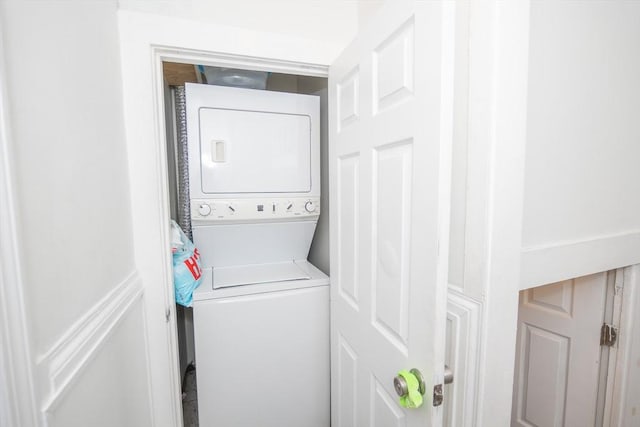 laundry room with laundry area and stacked washer / dryer