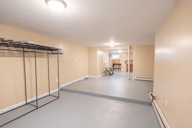 basement featuring baseboard heating, a baseboard radiator, and baseboards